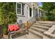 Inviting front entrance with a bench, red cushions, and decorative railings leading to the front door at 747 Channing Nw Dr, Atlanta, GA 30318
