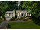 Charming home featuring a well-manicured front lawn and lush landscaping with mature trees and a driveway at 747 Channing Nw Dr, Atlanta, GA 30318