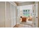 Hallway features tile flooring, leading to a living room with large windows and comfortable seating at 747 Channing Nw Dr, Atlanta, GA 30318