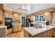 Well-lit kitchen featuring wood cabinets, black appliances, tile flooring, and countertop with food prep area at 747 Channing Nw Dr, Atlanta, GA 30318