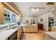 Spacious kitchen includes wood cabinets, stainless steel appliances, a tile floor, and a sink overlooking the backyard at 747 Channing Nw Dr, Atlanta, GA 30318