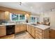 Bright kitchen features wood cabinets, a tile floor, stainless steel appliances, and a window overlooking the backyard at 747 Channing Nw Dr, Atlanta, GA 30318