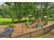 Community playground featuring green slides, climbing structures, picnic tables, and a wood chip groundcover at 747 Channing Nw Dr, Atlanta, GA 30318