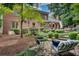 Large backyard featuring lush landscaping, seating, and a brick-and-wood exterior at 1676 Grove Park Way, Decatur, GA 30033