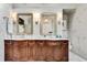 Bathroom featuring marble countertops, dual sinks, and dark wood cabinetry at 1676 Grove Park Way, Decatur, GA 30033