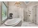 Large bathroom with a soaking tub, a glass enclosed shower, and marble floors at 1676 Grove Park Way, Decatur, GA 30033