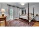 Well-lit bedroom with a four-poster bed, oriental rug, and matching bedside tables and decor at 1676 Grove Park Way, Decatur, GA 30033