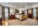 Comfortable bedroom with a coffered ceiling, hardwood floors, and neutral decor at 1676 Grove Park Way, Decatur, GA 30033