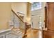 Bright foyer with hardwood floors, staircase, and high ceilings with transom window at 1676 Grove Park Way, Decatur, GA 30033