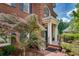 Brick home entrance with detailed columns, manicured shrubbery, and mature Japanese maple at 1676 Grove Park Way, Decatur, GA 30033