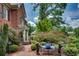 Brick pathway leading to the front entrance, surrounded by lush greenery and detailed landscaping at 1676 Grove Park Way, Decatur, GA 30033