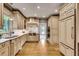 Open kitchen features stainless appliances, custom cabinets, and marble countertops and backsplash at 1676 Grove Park Way, Decatur, GA 30033