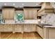 Well-lit kitchen boasts stainless appliances, custom cabinets, and marble countertops at 1676 Grove Park Way, Decatur, GA 30033