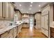 Bright kitchen features custom cabinets, stainless appliances, and marble countertops and backsplash at 1676 Grove Park Way, Decatur, GA 30033