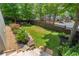 Landscaped backyard with lush lawn, decorative stone, and a dark wood privacy fence at 175 Centennial Trce, Roswell, GA 30076
