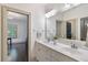 Bright bathroom featuring a double sink vanity and a doorway leading into an office space at 175 Centennial Trce, Roswell, GA 30076