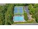 Aerial view of community pool and tennis courts surrounded by mature trees and parking area at 175 Centennial Trce, Roswell, GA 30076