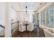Elegant dining area with a round table, comfortable seating, and natural light from the windows at 175 Centennial Trce, Roswell, GA 30076