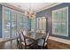 Elegant dining room with hardwood floors, chandelier and natural light from plantation shuttered windows at 175 Centennial Trce, Roswell, GA 30076