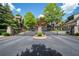 Stone entrance with black iron gates to a beautiful neighborhood surrounded by mature landscaping at 175 Centennial Trce, Roswell, GA 30076