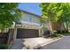 Two-story home featuring a two-car garage with a black door and light-green siding at 175 Centennial Trce, Roswell, GA 30076