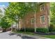 Brick house elevation surrounded by greenery, providing a charming and natural aesthetic at 175 Centennial Trce, Roswell, GA 30076