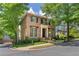 Charming brick home with lush landscaping, dark shutters, and a classic entryway, enhancing curb appeal at 175 Centennial Trce, Roswell, GA 30076