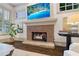 Close-up of the brick fireplace with a stone hearth, mounted television, and custom plantation shutters at 175 Centennial Trce, Roswell, GA 30076