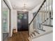 Stylish entryway with hardwood floors, staircase, and a dark wood door, offering a blend of elegance and comfort at 175 Centennial Trce, Roswell, GA 30076