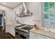 Gourmet kitchen with a high end stove and granite countertops and stainless vent hood at 175 Centennial Trce, Roswell, GA 30076