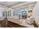 Inviting living room featuring a brick fireplace, plantation shutters, and beamed ceilings, perfect for entertaining at 175 Centennial Trce, Roswell, GA 30076
