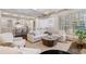 Open-concept living area showcasing kitchen island, large sectional sofa, and plantation shutters for great natural light at 175 Centennial Trce, Roswell, GA 30076
