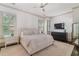Serene bedroom with neutral tones, a plush bed, and ample natural light from large windows at 175 Centennial Trce, Roswell, GA 30076