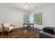 Office features hardwood floors, neutral walls, natural light, and a desk with accompanying chair at 175 Centennial Trce, Roswell, GA 30076