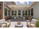Relaxing outdoor patio with stone floor, comfortable seating, and an abundance of natural light at 175 Centennial Trce, Roswell, GA 30076