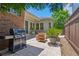 Outdoor patio with grill, stone flooring, outdoor seating, and a landscaped border, ideal for entertaining at 175 Centennial Trce, Roswell, GA 30076