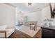 Bright sitting room with hardwood floors, white walls, and comfortable seating, illuminated by elegant lighting fixtures at 175 Centennial Trce, Roswell, GA 30076