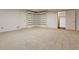 Large basement with neutral carpet and built in shelving, ready for storage or activities at 2528 Chimney Springs Dr, Marietta, GA 30062