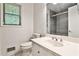 Well-lit bathroom featuring a white toilet, vanity with mirror, and tiled shower at 2528 Chimney Springs Dr, Marietta, GA 30062