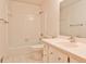 Cozy, white-tiled bathroom featuring a vanity, toilet, tub, and shower combination at 2528 Chimney Springs Dr, Marietta, GA 30062