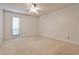 Bright, carpeted bedroom featuring a ceiling fan and large window with wooded view at 2528 Chimney Springs Dr, Marietta, GA 30062