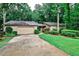 Well-maintained home with manicured landscaping and an attached garage, surrounded by mature trees at 2528 Chimney Springs Dr, Marietta, GA 30062