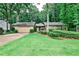 Charming single-story home with a lush green lawn, mature trees, and a two-car garage at 2528 Chimney Springs Dr, Marietta, GA 30062
