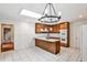 A large skylight illuminates the beautiful kitchen with wood cabinets and tile floors at 2528 Chimney Springs Dr, Marietta, GA 30062