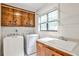 A practical laundry room is equipped with a sink, washer, dryer, and storage cabinets at 2528 Chimney Springs Dr, Marietta, GA 30062