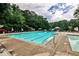 Spacious outdoor pool and separate wading pool, surrounded by lounge chairs and mature trees at 2528 Chimney Springs Dr, Marietta, GA 30062
