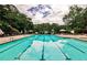 Sparkling blue pool surrounded by lounge chairs and umbrellas, perfect for relaxation and summer fun at 2528 Chimney Springs Dr, Marietta, GA 30062
