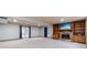 Basement with natural light, carpet floors, and a fireplace with a custom mantle and built-in shelves at 2645 Holly Berry Trl, Snellville, GA 30039