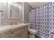 Clean bathroom with modern vanity, toilet, and shower with geometric patterned curtain at 2645 Holly Berry Trl, Snellville, GA 30039