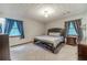 Cozy bedroom with neutral carpet, dresser, and bedside table at 2645 Holly Berry Trl, Snellville, GA 30039